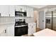 Bright kitchen with new stainless steel oven, and black hardware at 609 Delray Dr, Indianapolis, IN 46241