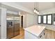 Modern kitchen with stainless steel refrigerator and an island with a white countertop at 609 Delray Dr, Indianapolis, IN 46241