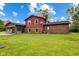 Expansive backyard featuring green grass and a brick exterior at 6123 W 46Th St, Indianapolis, IN 46254