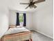 Small bedroom featuring a cozy bed, ceiling fan, and window at 6123 W 46Th St, Indianapolis, IN 46254