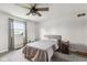 Bright bedroom with a cozy bed, ceiling fan, and view of the outdoors at 6123 W 46Th St, Indianapolis, IN 46254