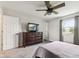 Neutral bedroom featuring a wood ceiling fan, dresser and TV at 6123 W 46Th St, Indianapolis, IN 46254