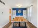 Bright dining room featuring hardwood floors, built-in shelving, and a modern light fixture at 6123 W 46Th St, Indianapolis, IN 46254