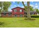Charming two-story home with brick facade, black shutters, and a well-manicured lawn at 6123 W 46Th St, Indianapolis, IN 46254