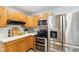 Bright kitchen featuring stainless steel appliances, hardwood floors, and ample counter space at 6123 W 46Th St, Indianapolis, IN 46254