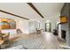 Spacious open living space featuring hardwood floors, a fireplace, and a seamless flow to the kitchen at 6123 W 46Th St, Indianapolis, IN 46254