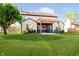 Spacious backyard features a covered patio area, perfect for outdoor entertaining and relaxation at 6144 Black Oaks Way, Indianapolis, IN 46237