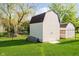 Backyard image featuring a classic outdoor shed on a well-maintained lawn, adding storage and charm to the property at 6144 Black Oaks Way, Indianapolis, IN 46237