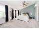 This main bedroom features carpeted floors, a fan, an accent wall, and plenty of natural light from the windows at 6144 Black Oaks Way, Indianapolis, IN 46237
