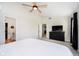 This bedroom features carpeted floors, a ceiling fan, and a black dresser with a flatscreen TV at 6144 Black Oaks Way, Indianapolis, IN 46237