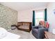 This charming Bedroom features floral wallpaper, a wooden crib, a comfortable chair, and soft lighting at 6144 Black Oaks Way, Indianapolis, IN 46237