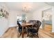 Elegant dining room featuring a wooden table with seating for six under a chandelier at 6144 Black Oaks Way, Indianapolis, IN 46237