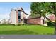 Landscaped yard showing brick and vinyl exterior on corner lot with mature shade tree at 6144 Black Oaks Way, Indianapolis, IN 46237