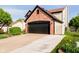 Exterior view of brick facade with a two-car garage and a well-kept lawn at 6144 Black Oaks Way, Indianapolis, IN 46237