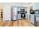 Modern kitchen features updated stainless steel appliances, sleek blue cabinetry, and stylish backsplash at 6144 Black Oaks Way, Indianapolis, IN 46237