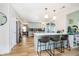 Spacious kitchen featuring a breakfast bar, stainless steel appliances, and hardwood floors throughout at 6144 Black Oaks Way, Indianapolis, IN 46237