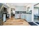 Open-concept kitchen features stainless steel appliances, blue cabinetry, and access to the patio at 6144 Black Oaks Way, Indianapolis, IN 46237