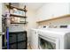 Well-organized laundry room with washer, dryer, shelving, and storage solutions at 6144 Black Oaks Way, Indianapolis, IN 46237