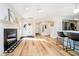 Open-concept living room features a fireplace, hardwood floors, and flows into the updated kitchen at 6144 Black Oaks Way, Indianapolis, IN 46237