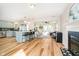 Open-concept living room and kitchen boasts hardwood floors, a fireplace, and ample natural light at 6144 Black Oaks Way, Indianapolis, IN 46237