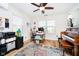Bright office space with natural light, featuring a desk, piano, and colorful decor at 6144 Black Oaks Way, Indianapolis, IN 46237