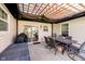 Enjoy outdoor dining under a pergola on the patio, complete with grill and dining table for entertaining at 6144 Black Oaks Way, Indianapolis, IN 46237