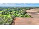 Panoramic aerial view of a home with lush grounds, pond, trees, and bordering farmland on a clear day at 6149 W Olive Branch Rd, Greenwood, IN 46143