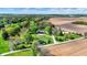 Idyllic aerial view of a home with large yard, mature trees, pond, and surrounding farmland on a sunny day at 6149 W Olive Branch Rd, Greenwood, IN 46143