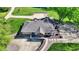 Aerial view of home featuring a large driveway, stone accents, and lush landscaping at 6149 W Olive Branch Rd, Greenwood, IN 46143
