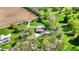 Aerial view of a home with mature trees, pond, and well manicured lawn at 6149 W Olive Branch Rd, Greenwood, IN 46143