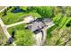 Aerial view showcasing a luxurious home with a long driveway and a serene pond at 6149 W Olive Branch Rd, Greenwood, IN 46143