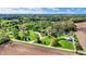Expansive aerial view of a home on a large lot with lush landscaping, nearby pond, and surrounding farmland at 6149 W Olive Branch Rd, Greenwood, IN 46143