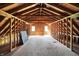 Unfinished attic showcasing exposed wooden beams and a frame for potential expansion at 6149 W Olive Branch Rd, Greenwood, IN 46143