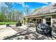 Brick home featuring a stone patio with a dining table, grills, and manicured landscaping at 6149 W Olive Branch Rd, Greenwood, IN 46143