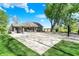 Spacious backyard with a basketball court, patio, and green grass at 6149 W Olive Branch Rd, Greenwood, IN 46143