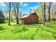 Rustic barn nestled among mature trees, blending charm and functionality at 6149 W Olive Branch Rd, Greenwood, IN 46143