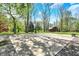 Outdoor basketball court surrounded by mature trees provides a great recreation space at 6149 W Olive Branch Rd, Greenwood, IN 46143