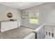 Charming Bedroom with gray walls, white trim, and a window overlooking the green outdoors at 6149 W Olive Branch Rd, Greenwood, IN 46143