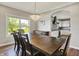 Open concept dining room flows into kitchen; chandelier adds elegance and charm at 6149 W Olive Branch Rd, Greenwood, IN 46143