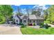 Well-manicured lawn surrounds this beautiful brick home with inviting landscaping and stone accents at 6149 W Olive Branch Rd, Greenwood, IN 46143