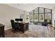 Home office featuring natural light from many windows, dark wood desk and neutral colors at 6149 W Olive Branch Rd, Greenwood, IN 46143