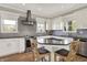 Bright kitchen featuring white cabinets, stainless steel appliances, and center island with seating at 6149 W Olive Branch Rd, Greenwood, IN 46143