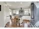 Modern kitchen with white cabinets, stainless appliances, island seating, and wood floors at 6149 W Olive Branch Rd, Greenwood, IN 46143