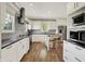 Well-lit kitchen features stainless steel appliances, white cabinets, and modern finishes at 6149 W Olive Branch Rd, Greenwood, IN 46143