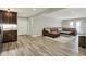 Finished basement with wood floors, a large brown leather sectional, and a kitchenette with dark wood cabinets at 6149 W Olive Branch Rd, Greenwood, IN 46143