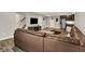 Spacious finished basement with brown leather couches, a tv, and a kitchenette with stainless steel appliances at 6149 W Olive Branch Rd, Greenwood, IN 46143