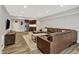 Spacious finished basement with wood floors, brown leather couches and a stainless steel kitchenette at 6149 W Olive Branch Rd, Greenwood, IN 46143