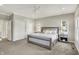 Bright main bedroom with carpet, neutral colors and a large bed with side tables at 6149 W Olive Branch Rd, Greenwood, IN 46143