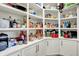Walk-in pantry featuring custom shelving, ample storage and white cabinetry at 6149 W Olive Branch Rd, Greenwood, IN 46143