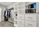 Organized walk-in closet with custom shelves, drawers, and hanging racks for optimal storage at 6149 W Olive Branch Rd, Greenwood, IN 46143